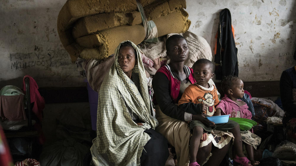 Mothers and their children sit Tuesday at a displacement center in Blantyre, Malawi.