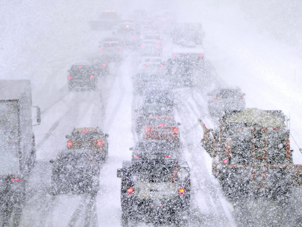 Plows, at right, try to pass crawling traffic in the snow on Route 93 South in Londonderry, N.H., Tuesday. The storm is expected to continue into early Wednesday.