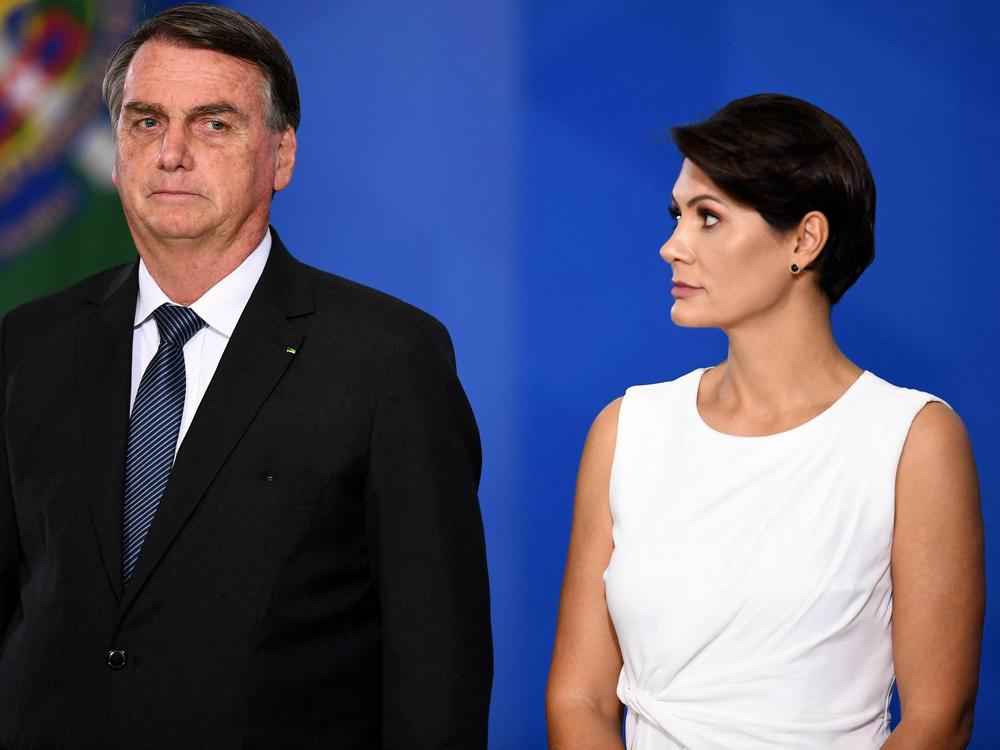 Bolsonaro stands next to his wife Michelle during a military officers promotion ceremony, at Planalto Palace in Brasília, on Aug. 4, 2022.