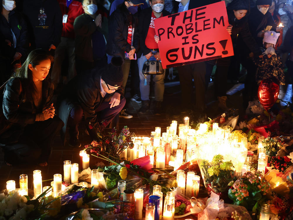 People attend a candlelight vigil for victims of a deadly mass shooting on Jan. 24 in Monterey Park, Calif. President Biden will announce his latest gun safety push there on Tuesday.