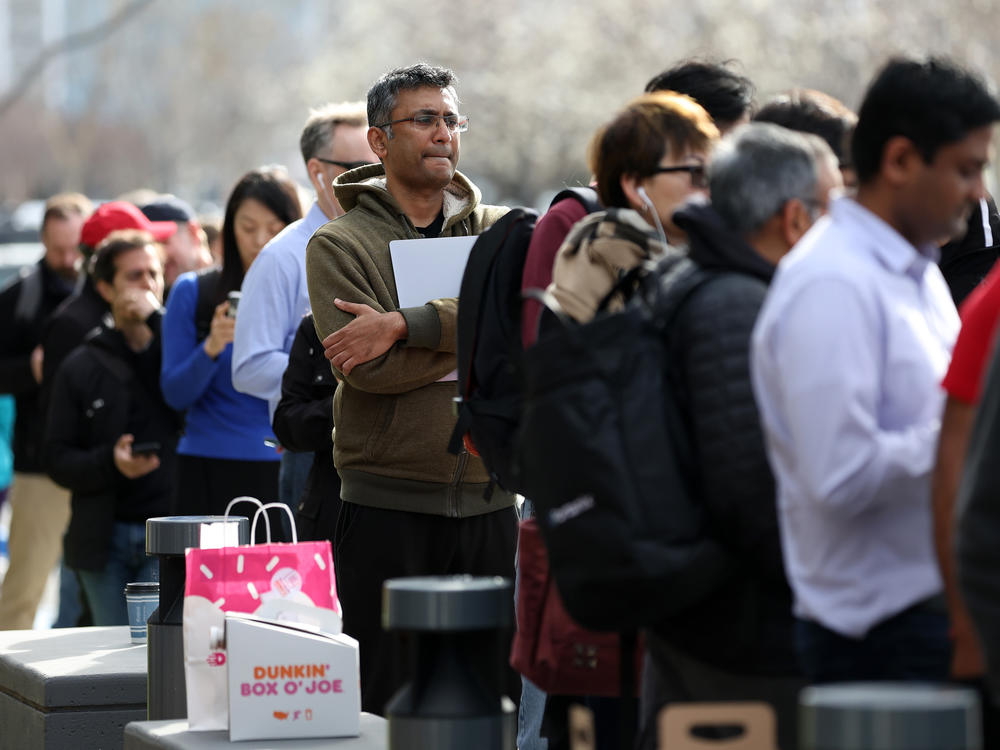People line up outside of a Silicon Valley Bank office to try to collect their money on Monday after SVB's collapse.