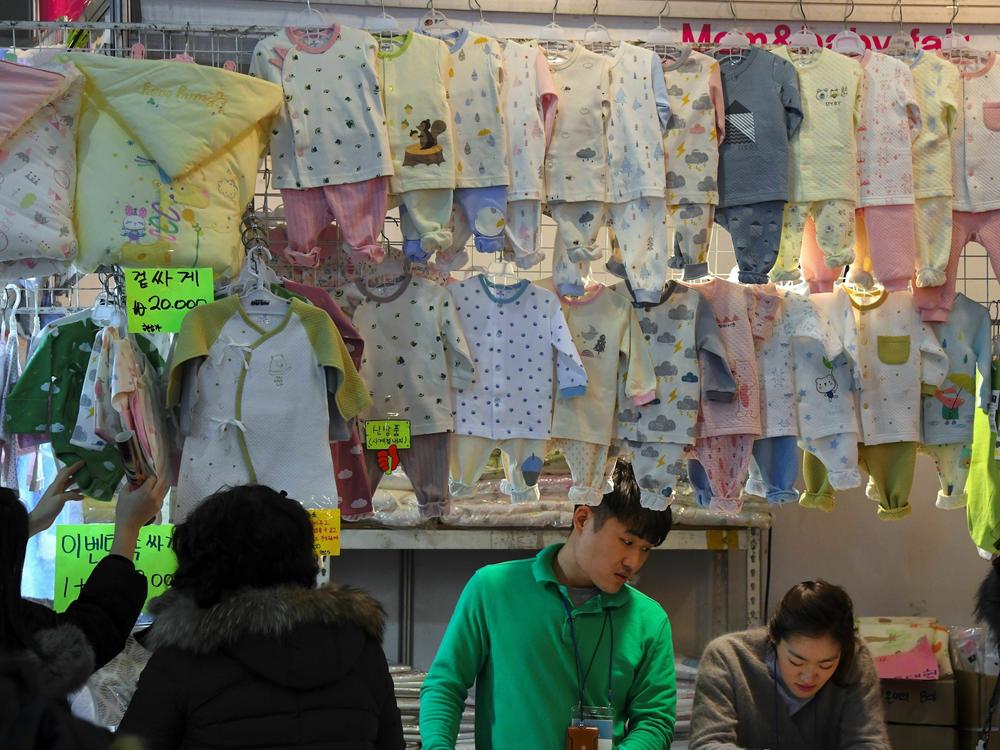 This picture taken in December 2017 shows baby clothes displayed at a baby fair in Seoul. Rapid economic growth over several decades has seen South Korea's GDP boom, but birth rates have gone in the opposite direction.
