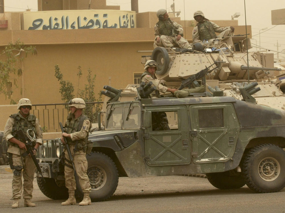 U.S. soldiers stand guard in Fallujah, May 2003. Congress will vote on whether to repeal the authorization for the use of military force orders passed in 1991 and in 2002 for two separate armed conflicts in Iraq.