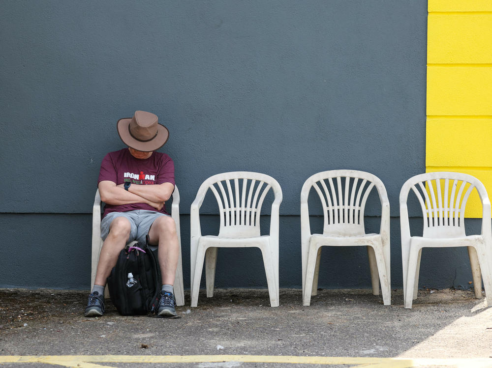 A spectator sleeps during IRONMAN Ireland on Aug. 14, 2022, in Cork, Ireland.