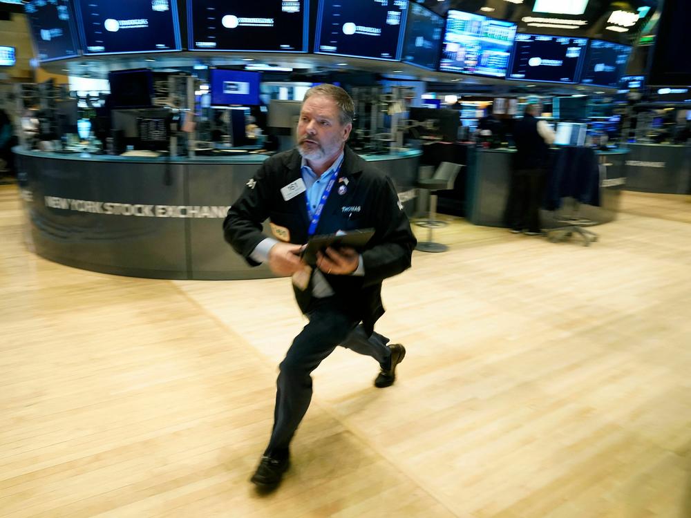Traders work on the floor of the New York Stock Exchange in New York City on Tuesday. Stocks tumbled on Wednesday amid fears that worries about the banking system were widening to other parts of the world.