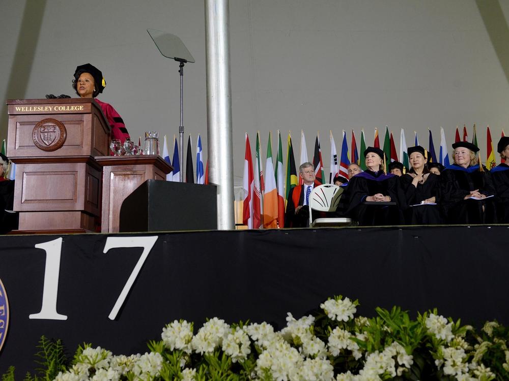 Wellesley College President Paula Johnson speaks at commencement as Hillary Clinton looks on in May 2017.