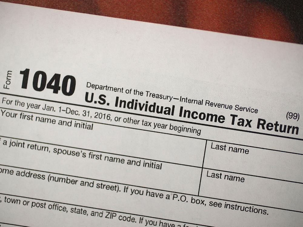 A copy of a IRS 1040 tax form is seen at an H&R Block office on the day President Donald Trump signed the Republican tax cut bill in Washington, DC on December 22, 2017 in Miami, Florida.