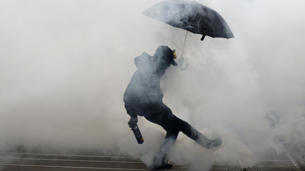 Protesters kicks a teargas canister as he clashes with police during a demonstration in Nantes, western France, on Wednesday.