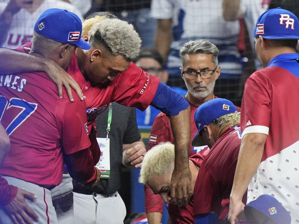 Puerto Rico pitcher Edwin Díaz is helped into a wheelchair after he appeared to injure himself during a postgame celebration after Puerto Rico beat the Dominican Republic 5-2 during a World Baseball Classic game on Wednesday in Miami.