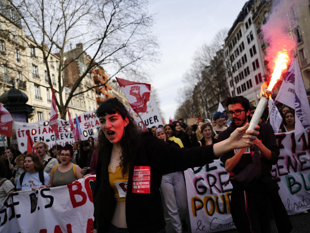 Students shout slogans during a demonstration against the government's plan to raise the retirement age to 64 in Paris on Thursday. French President Emmanuel Macron has shunned parliament and opted to push through a highly unpopular bill that would raise the retirement age from 62 to 64 by triggering a special constitutional power.