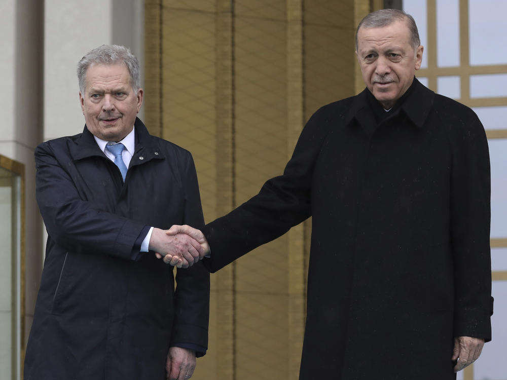 Turkish President Recep Tayyip Erdogan, right, and Finland's President Sauli Niinisto shake hands during a welcome ceremony at the presidential palace in Ankara, Turkey, on Friday.