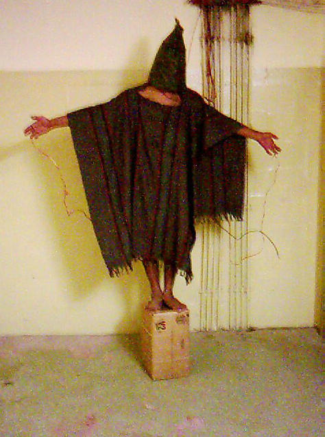 April 28, 2004: This late 2003 file image obtained by The Associated Press shows an unidentified detainee standing on a box with a bag on his head and wires attached to him, at the Abu Ghraib prison.