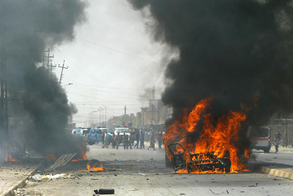 July 23, 2010: Smoke billows from a burning car in the northern Iraqi city of Kirkuk following a blast that seriously wounded the city's police chief, Borhan Habib Tayeb, and killed his son.