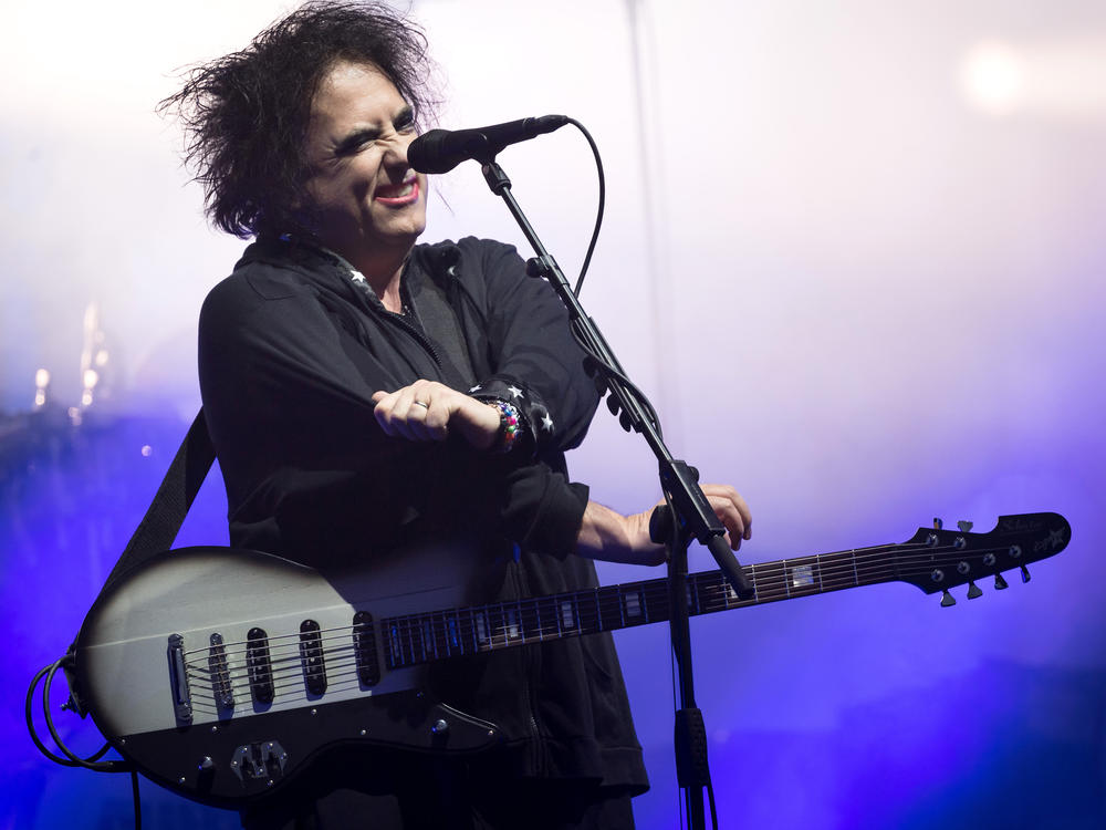 Robert Smith of The Cure performs in Glastonbury, England, in 2019. This week, he shared his frustrations with Ticketmaster, and announced Thursday that the company would lower fees and offer partial refunds to The Cure's ticket purchasers.