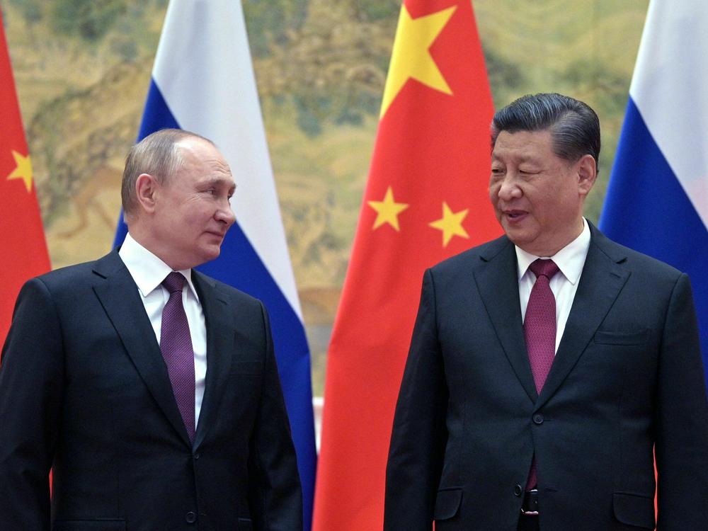 Russian President Vladimir Putin and Chinese President Xi Jinping pose for a photograph during their meeting in Beijing, on Feb. 4, 2022