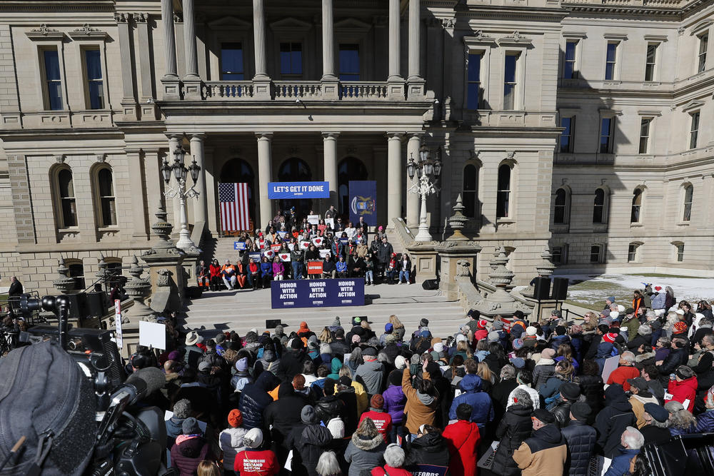 A large crowd attends a rally to demand action on gun safety at the Michigan State Capitol on March 15, 2023, in Lansing, Mich. The rally comes as gun safety bills are making their way through the Michigan legislature.