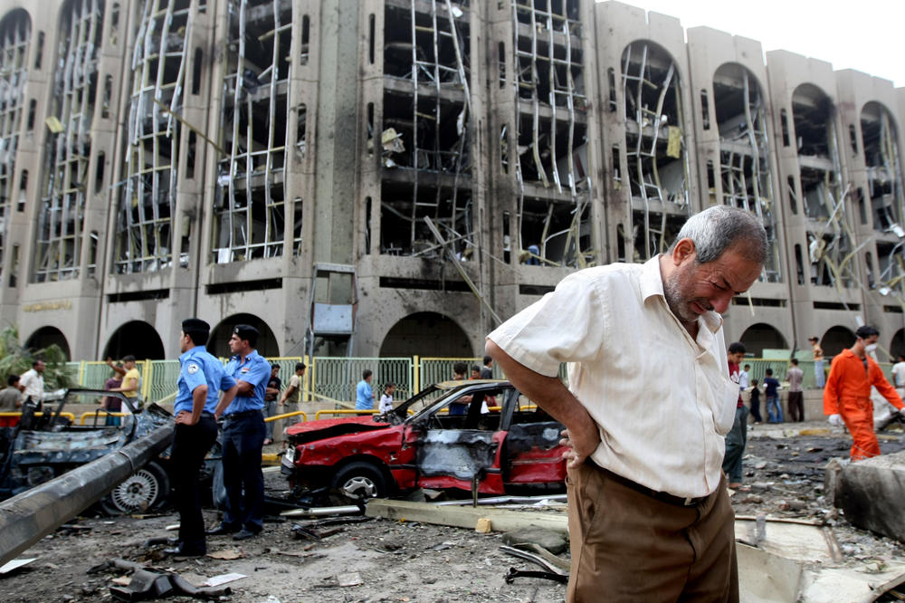 Oct. 25, 2009: An Iraqi weeps as he walks away from the ministries of justice and labor following a suicide bombing. Twin suicide car bombs blasted the justice ministry and the provincial offices in central Baghdad, killing at least 90 people and injuring 600 others.
