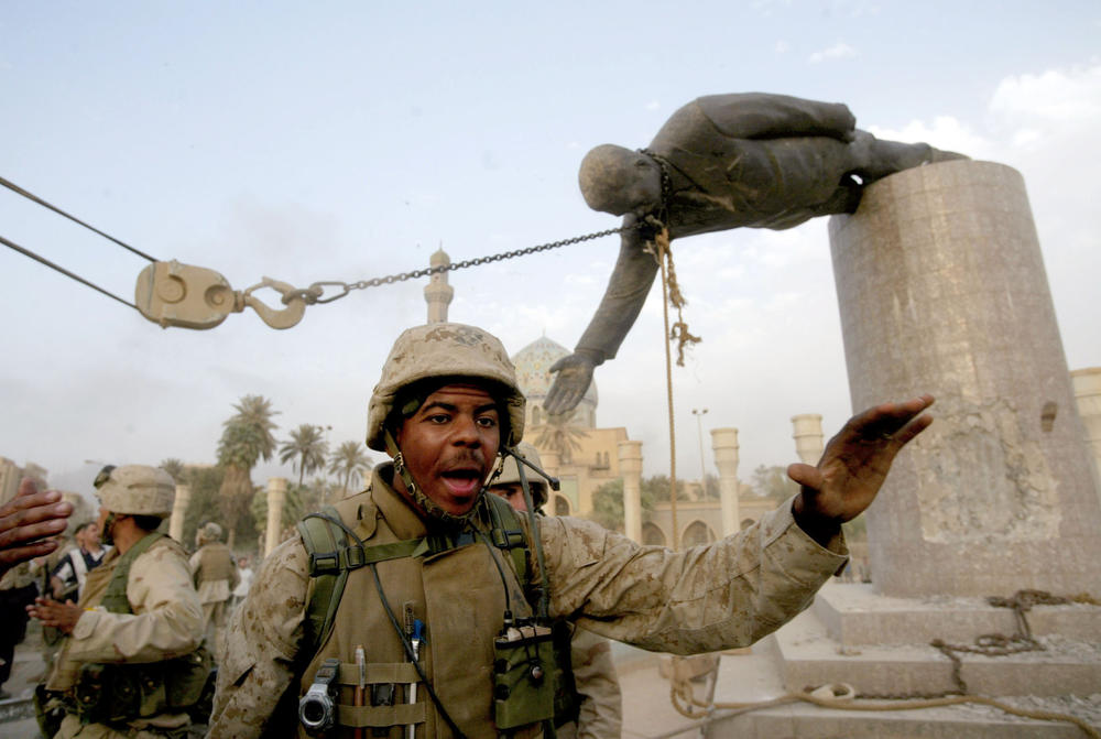 April 9, 2003: U.S. Marines pull down a statue of Saddam Hussein in the center of Baghdad.