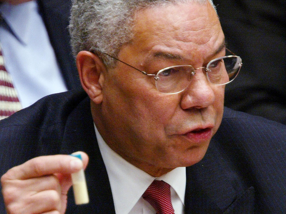 U.S. Secretary of State Colin Powell holds a vial representing the small amount of anthrax that closed the U.S. Senate in 2002 during his address to the U.N. Security Council on Feb. 5, 2003, in New York City. Powell was making a presentation attempting to convince the world that Iraq was deliberately hiding weapons of mass destruction.