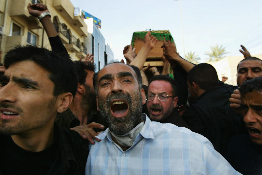 March 3, 2004: Iraqi mourners carry the coffins of those killed the day before in a series of explosions in the Shia holy city of Karbala.