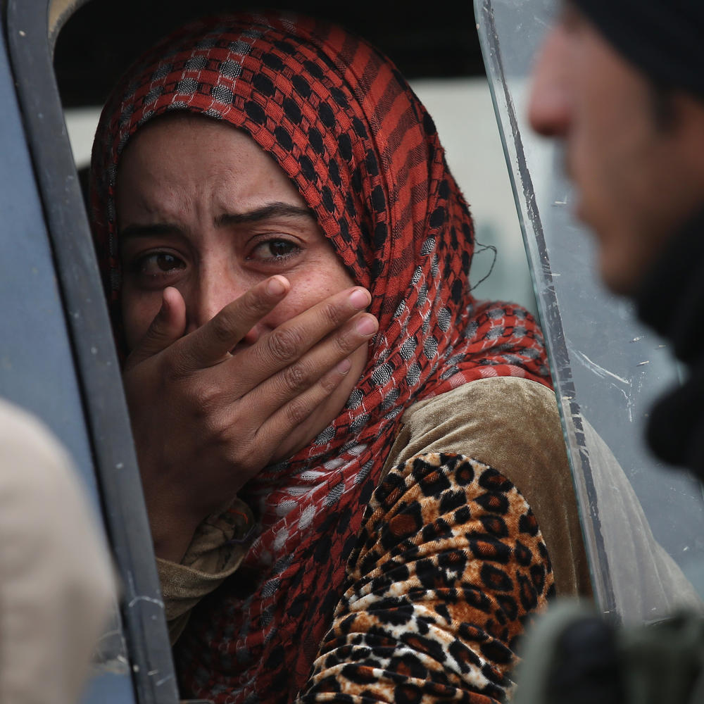 A woman from an Arabic family cries after her family was denied entry to a Kurdish-controlled area from an ISIS-held village in late 2015 near Sinjar, Iraq.