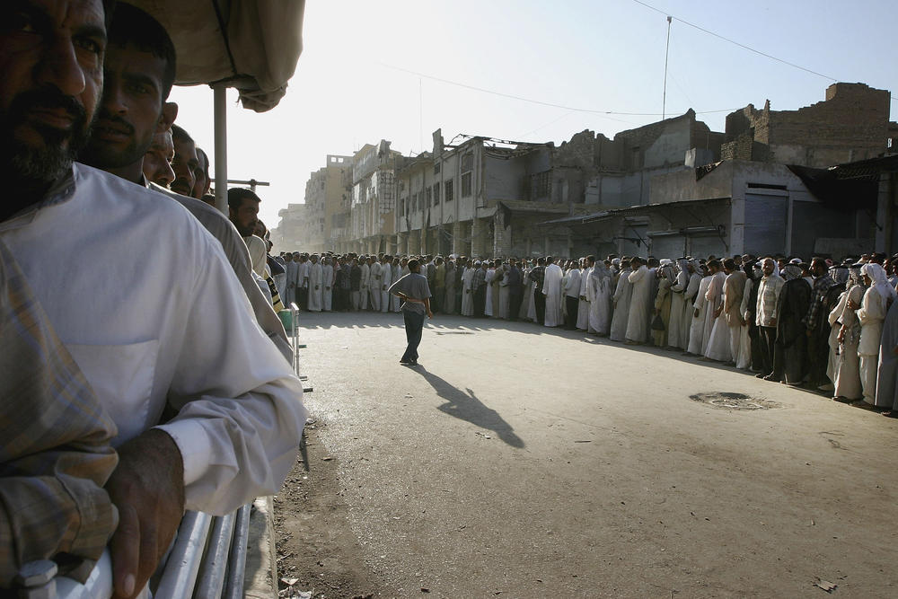 Aug. 27, 2004: Iraqi Shia faithful line up outside the shrine of Imam Ali in Najaf, to mark the end of conflict. The rebel leader Moqtada al-Sadr ordered his fighters to lay down their arms in a peace deal brokered by Iraq's most revered Shia cleric, Grand Ayatollah Ali al-Sistani.