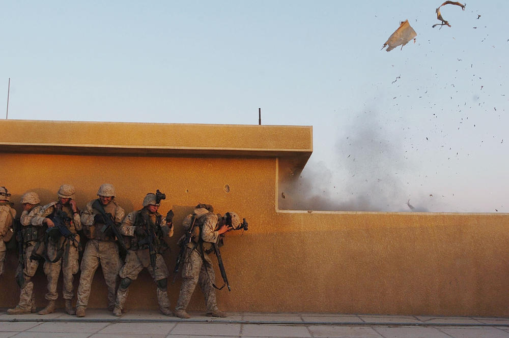Nov. 22, 2004: U.S. Marines use explosives to open rooftop doors as they search houses for insurgents on in Fallujah, Iraq.