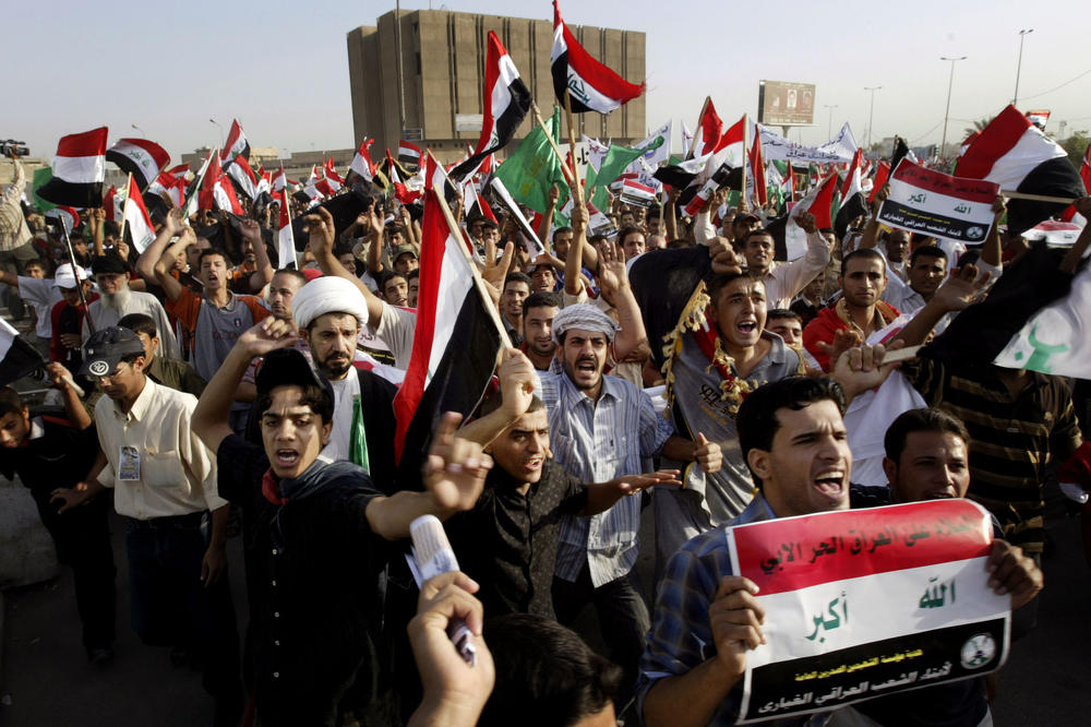 Oct. 18, 2008: Shia demonstrators carry Iraqi flags during a protest against a proposed U.S.-Iraqi security pact in Baghdad.