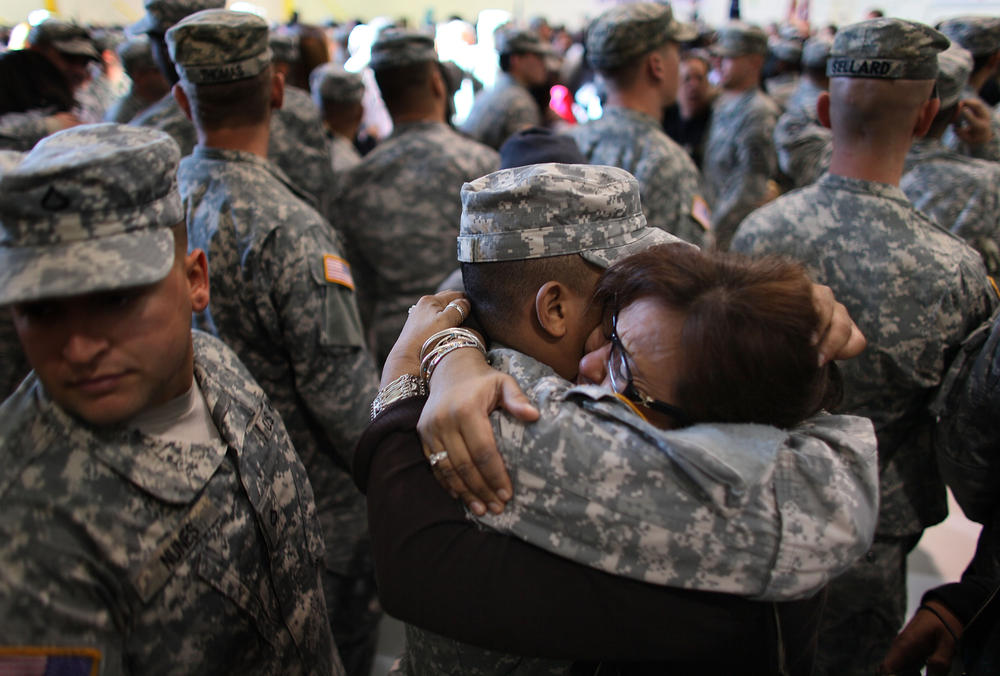 Jan. 5, 2010: U.S. Army National Guard Spc. Jose Guillen-Verde hugs his mother, Denia Metivier, during a deployment ceremony in Fort Lauderdale, Fla.