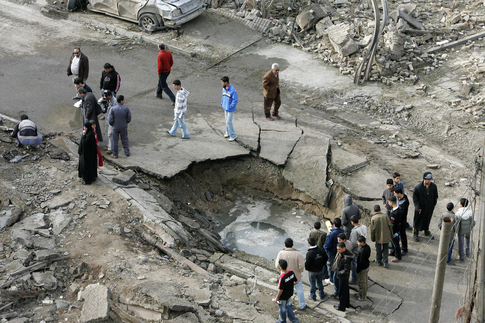 Jan. 26, 2010: A crater marks the site of a car bomb's explosion near the Al-Hamra hotel in Baghdad. Three car bombs targeted hotels used by foreign journalists and businessmen in Baghdad.