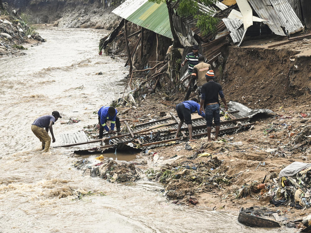 Residents in southern Malawi repair a home destroyed by heavy rain from Cyclone Freddy. Climate change is causing cyclones and hurricanes to get more intense and dangerous.