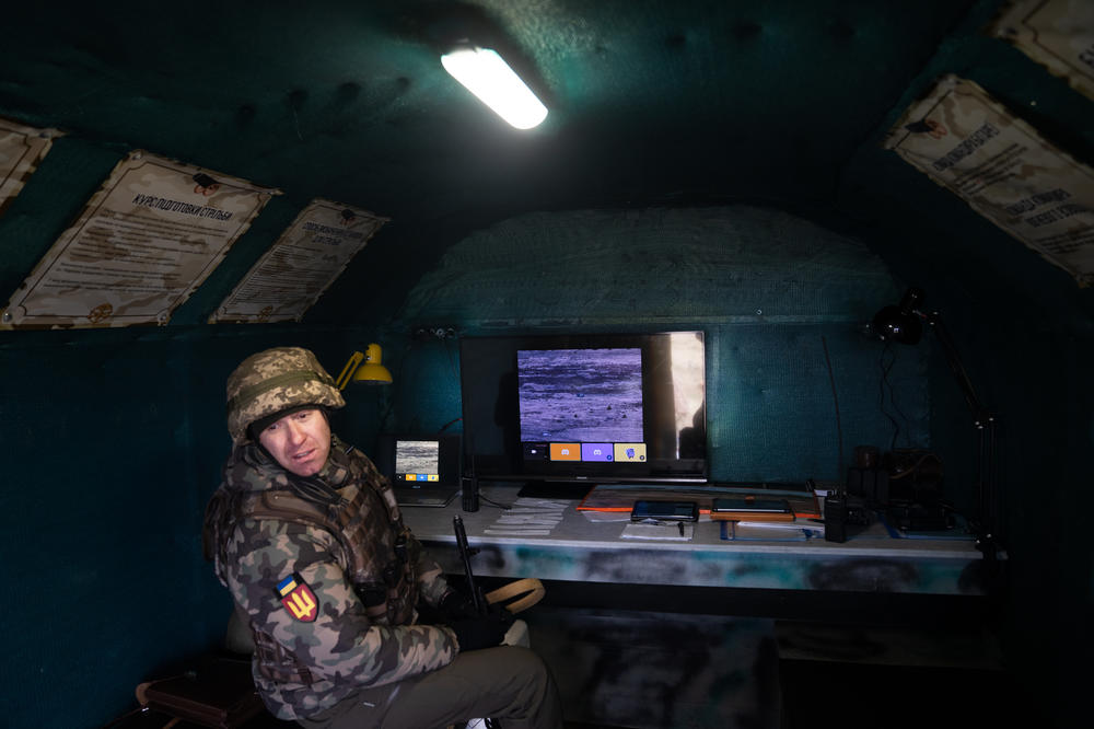 A soldier tests out monitoring the drone.