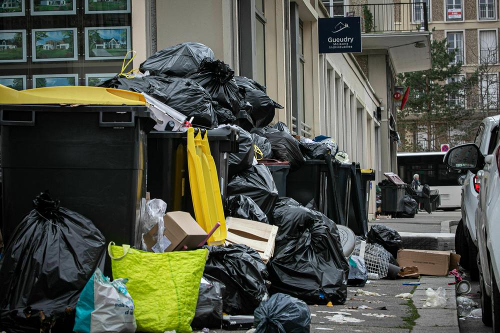 Trash has been piling up the street amid a bin collectors' strike against the pension changes.