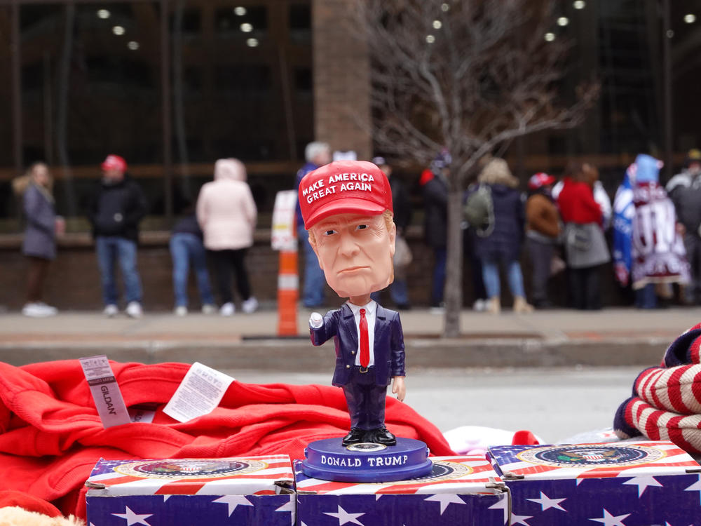 Merchandise is displayed for sale as guests wait in line to hear former President Donald Trump deliver a campaign speech in Iowa earlier this month.