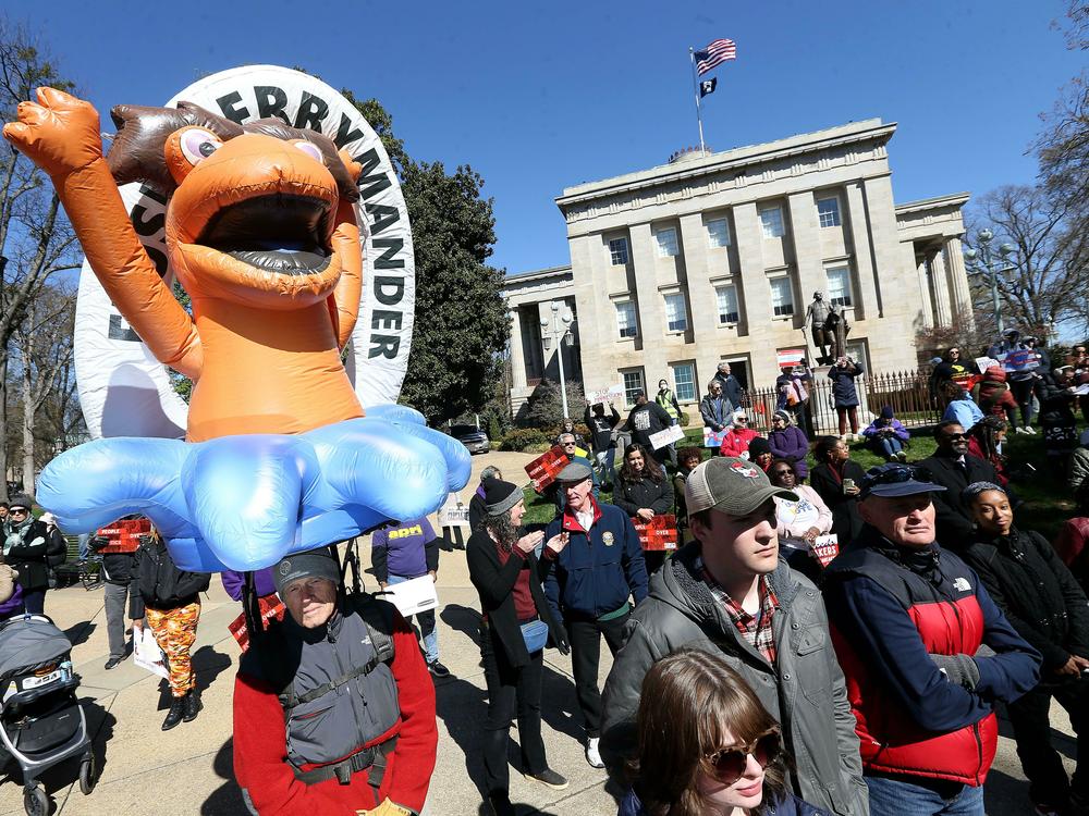 Demonstrators gather outside the North Carolina State Capitol in Raleigh, N.C., with a 