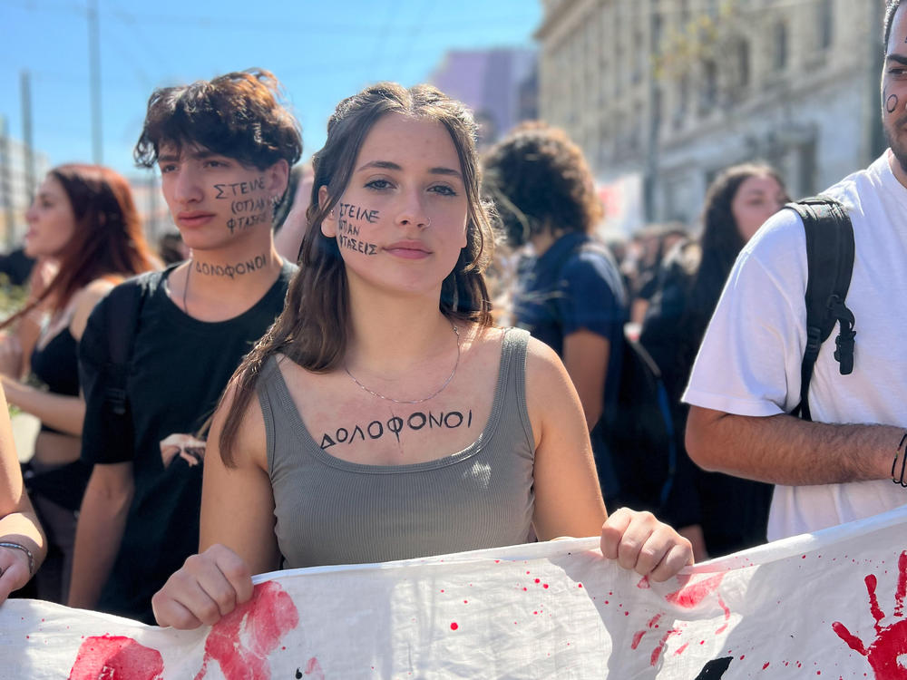 Stella Dourou and her high school classmates march in Athens in March. Written on Dourou's cheek: 