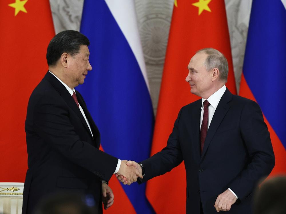 Russian President Vladimir Putin, right, and Chinese President Xi Jinping shake hands after speaking to the media during a signing ceremony following their talks in Moscow on Tuesday.
