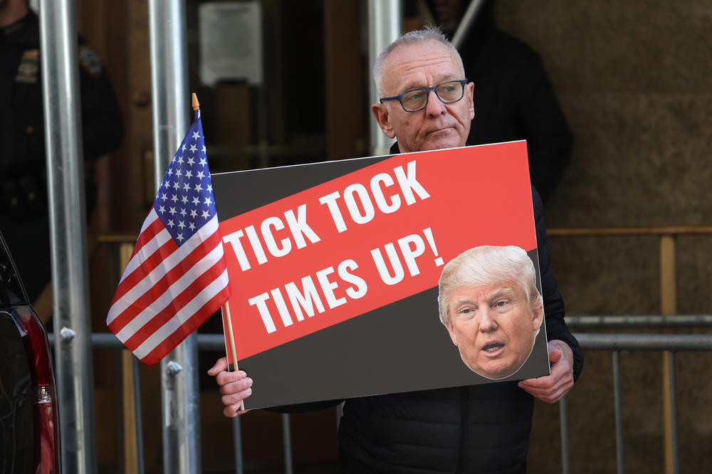 Demonstrators gather outside of Manhattan Criminal Court as a grand jury prepares to vote on whether to indict Donald Trump.