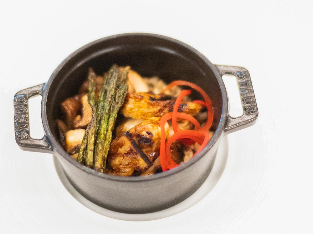 GOOD Meat cultivated chicken fillet cooked in a pot, with asparagus and mushrooms. The dish was created without killing a bird.