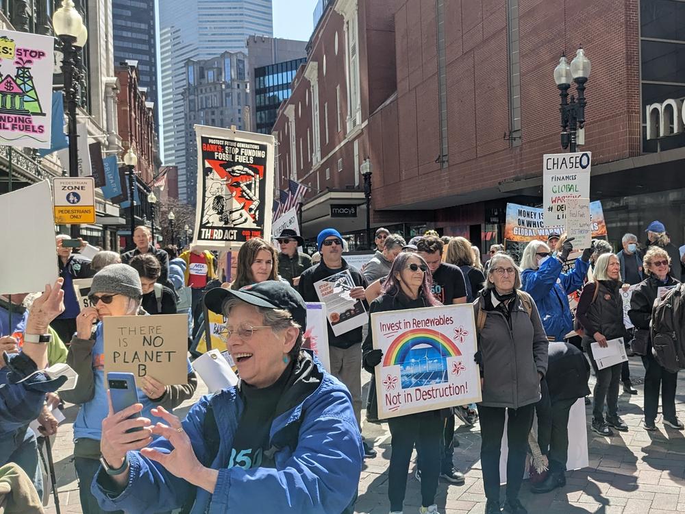 Climate activists in Boston gathered in front of a Chase Bank and marched to a Bank of America branch as part of a nationwide effort to urge banks to stop investing in fossil fuel projects.
