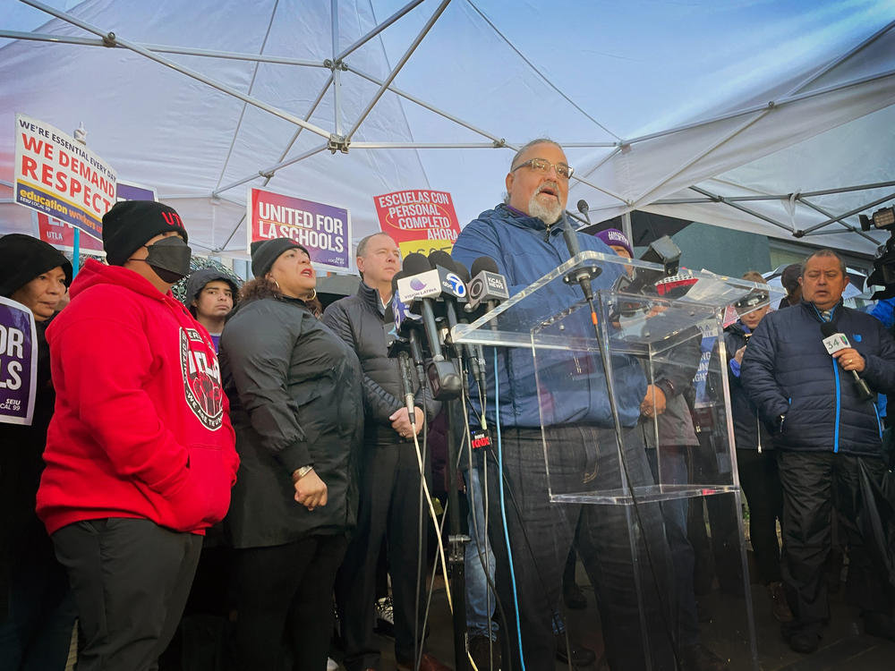 Max Arias, Executive Director of the SEIU Local 99 union speaks to members of the press and community at a demonstration outside of Robert F. Kennedy Community School in Koreatown. Behind him is Cecily Myart-Cruz, the president of the UTLA teachers union, and U.S. Rep. Adam Schiff (D-CA).