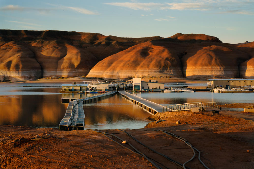 Dawn at Bullfrog Marina on Lake Powell in Utah. Waterlines on the rocks in the background show how far the water has dropped in recent years.