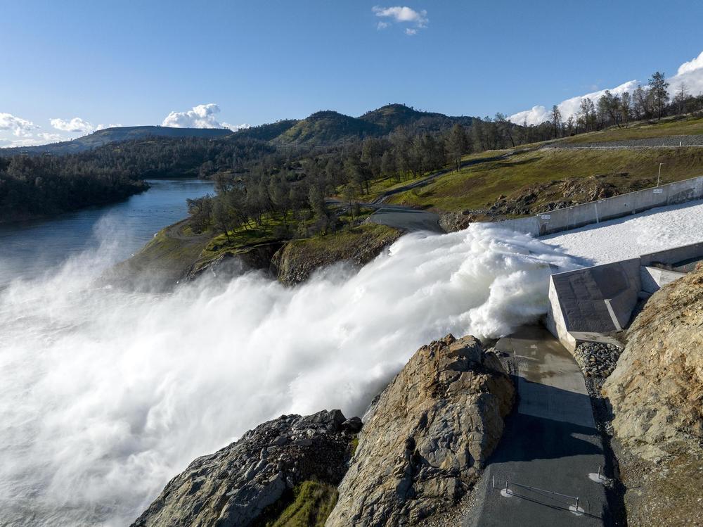 Water pours out of Lake Oroville in Northern California in March. Reservoirs levels plummeted over the last three years, but now have more water than they can hold.