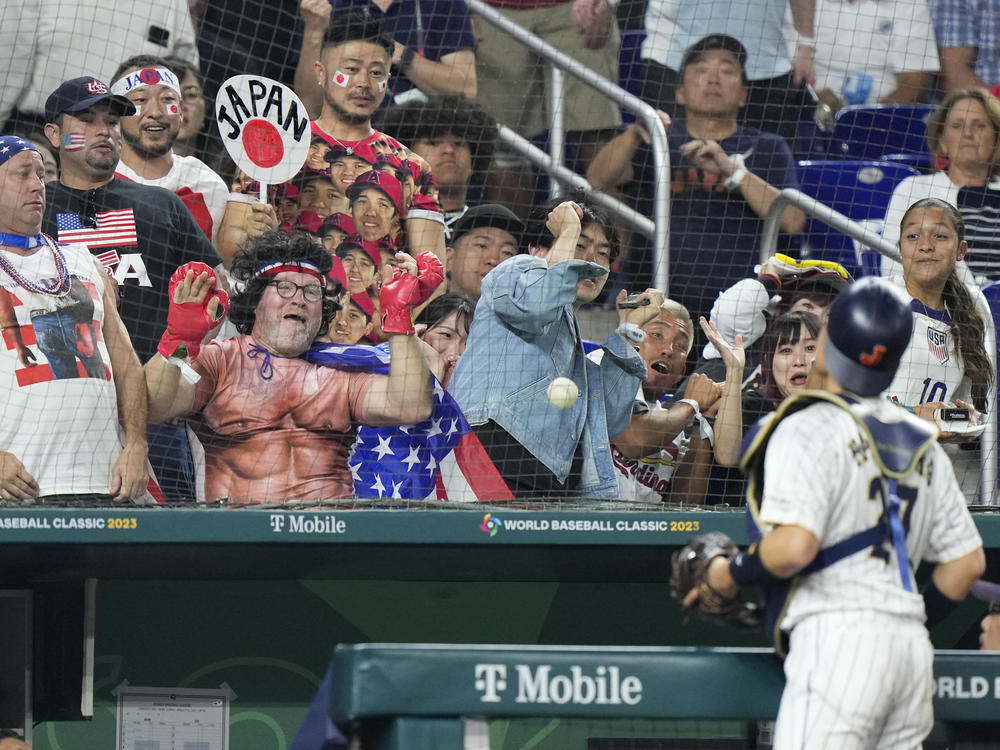 Japan catcher Yuhei Nakamura chases a foul ball during third inning of a World Baseball Classic championship game against the United States, Tuesday, March 21, 2023, in Miami. (AP Photo/Wilfredo Lee)