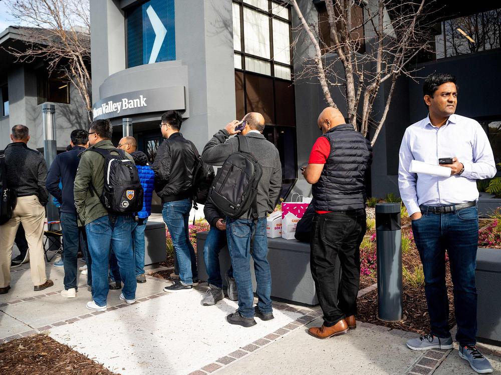 Silicon Valley Bank customers wait in line in Santa Clara, Calif. on March 13 after regulators took over the collapsed bank.