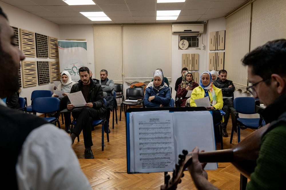Participants of a class sing a song blending Arabic, Turkish, and Farsi, during a session run by Ibrahim Muslimani, the founder and CEO of Nefes Music School, in Gaziantep, Turkey, on Nov. 22, 2022.
