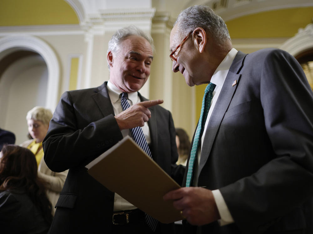 Democratic Sen. Tim Kaine of Virginia speaks with Senate Majority Leader Charles Schumer on March 15. Kaine led the bipartisan effort to repeal the Iraq Authorization for Use of Military Force with Indiana Republican Todd Young.