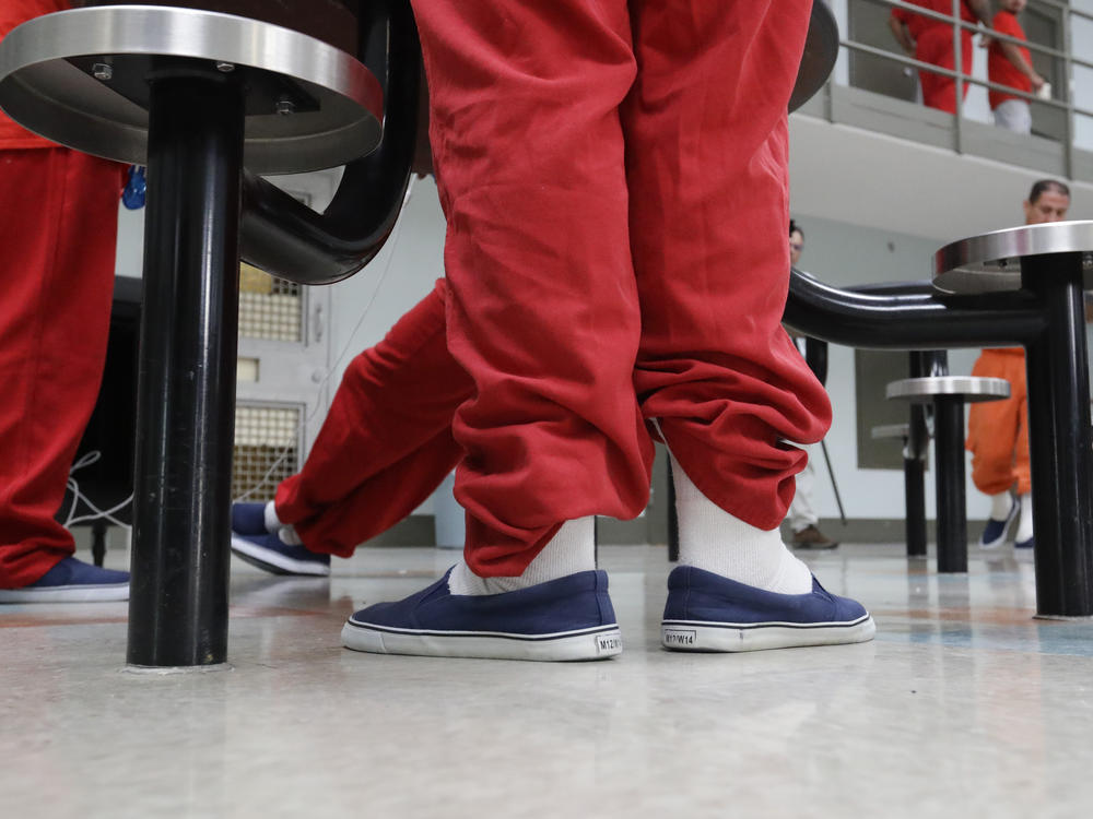 Detainees gather in a common area in 2019 at one of the housing units at the Adelanto ICE Processing Center in Adelanto, Calif.