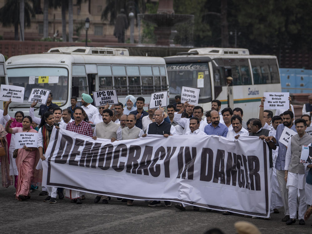 Lawmakers from India's opposition Congress and other parties hold a banner as they march against the Narendra Modi-led government alleging that Indian democracy is in danger, during a protest outside India's parliament in New Delhi, on Friday.