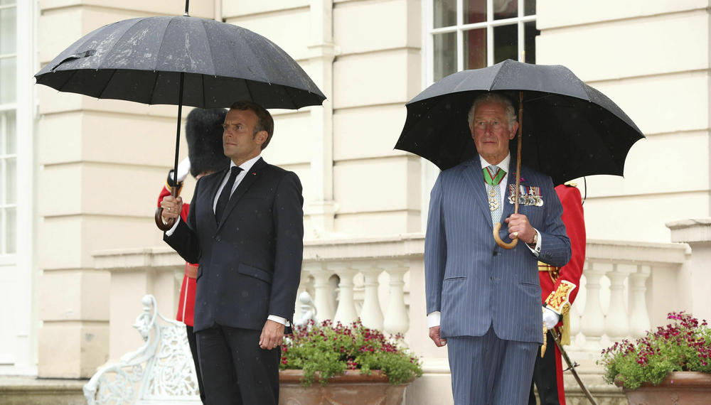 Britain's then-Prince Charles welcomes French president Emmanuel Macron to Clarence House in London on June 18, 2020.